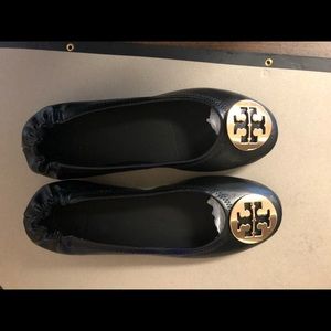 Tory Burch black flats with gold emblem detail.  Brand new never worn.